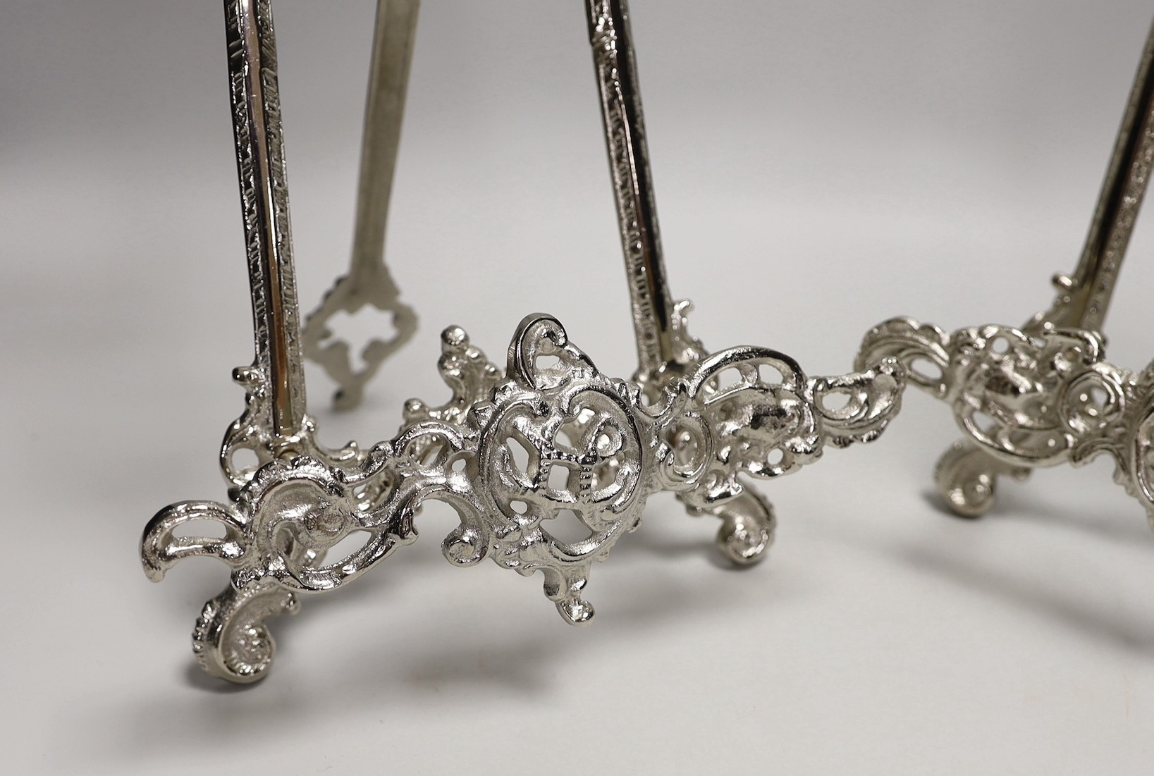 A pair of silver plated Rococo style easels, 41cm